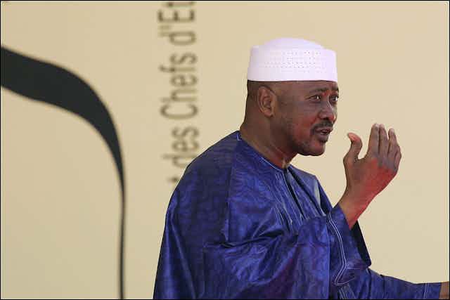 Head and shoulders of Amadou Toumani Toure gesturing while speaking