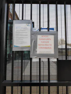 School gate with notices that the school is closed