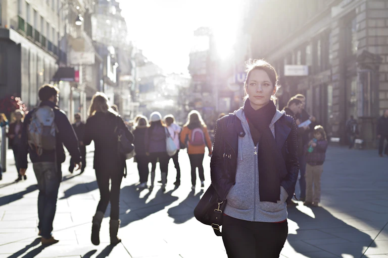 A woman on a city street not wearing a mask