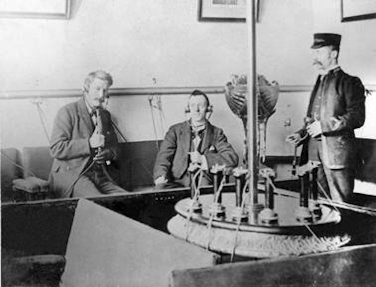 Three men in Victorian England listening to the new Electrophone technology
