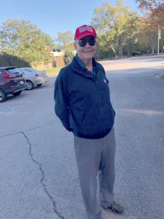 A smiling man wearing a Make America Great Again cap.