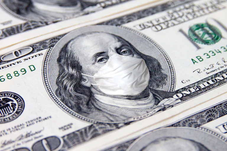 A US hundred dollar bill with Ben Franklin wearing a mask.