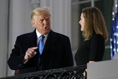 Donald Trump talks to Amy Coney Barrett.