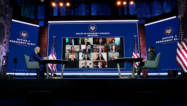 Biden and Harris in front of large virtual meeting screen