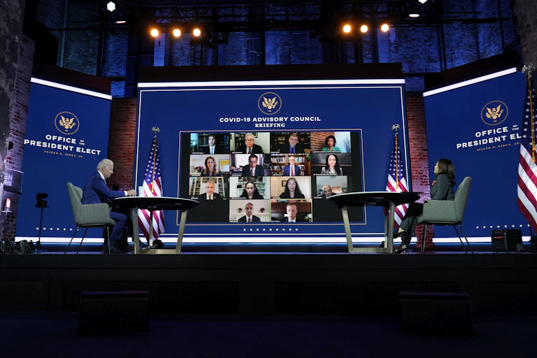 Biden and Harris in front of large virtual meeting screen