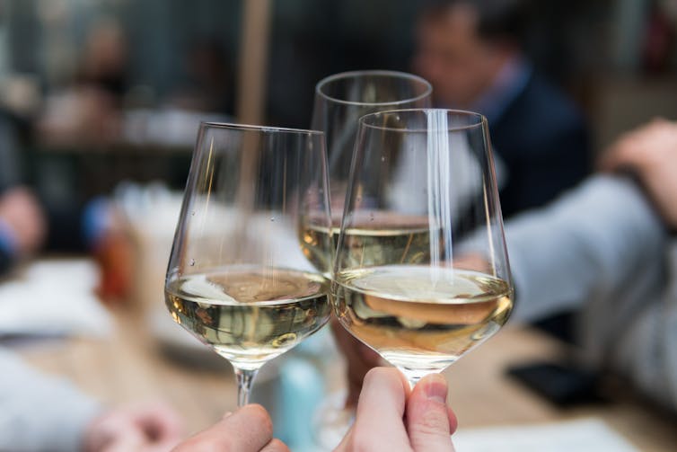 Wine glasses meeting for a toast.