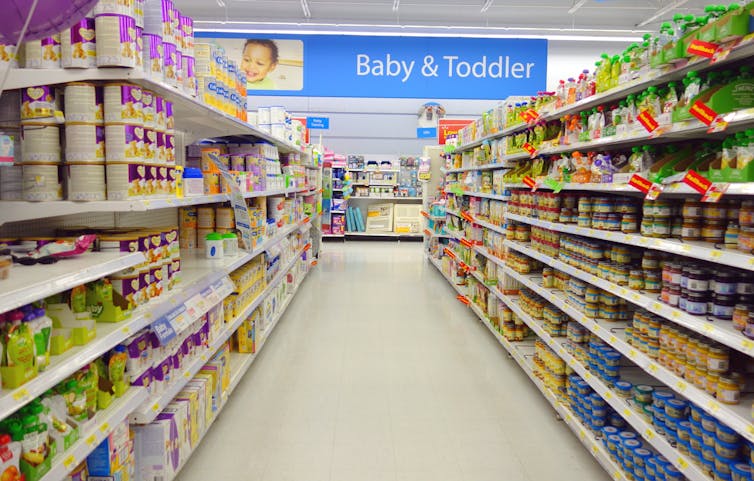 A grocery store aisle full of baby and toddler formula products.