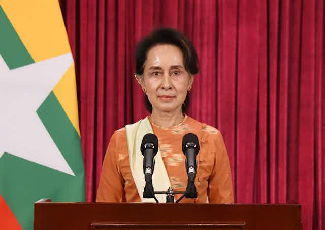 Myanmar leader Aung San Suu Kyi making a speech at a podium.