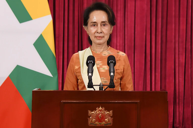 Myanmar leader Aung San Suu Kyi making a speech at a podium.