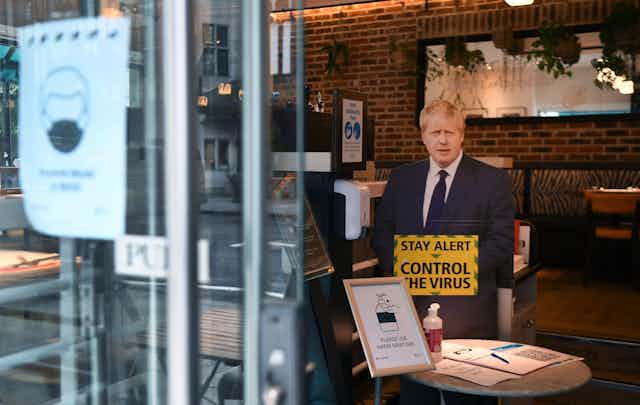 A cardboard cut out of Boris Johnson in a cafe.