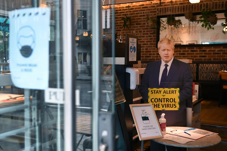 A cardboard cut out of Boris Johnson in a cafe.