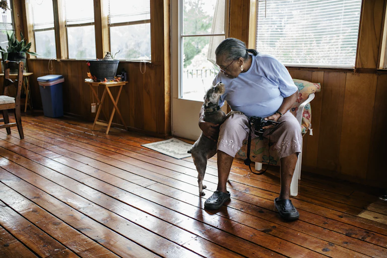 A woman and her pet dog at home.