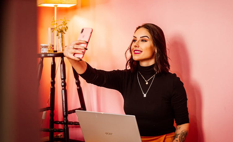 Woman takes selfie at home