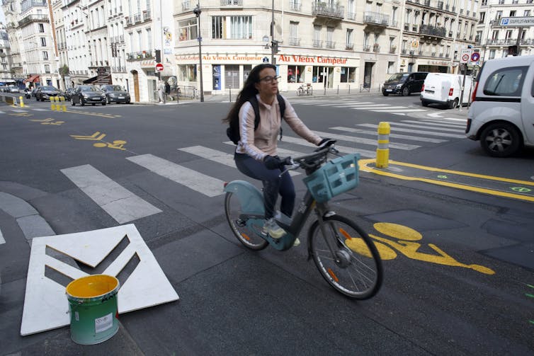 woman riding a bicycle on a city street