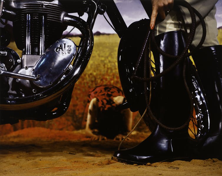 Close up photo: a motorbike and a boot