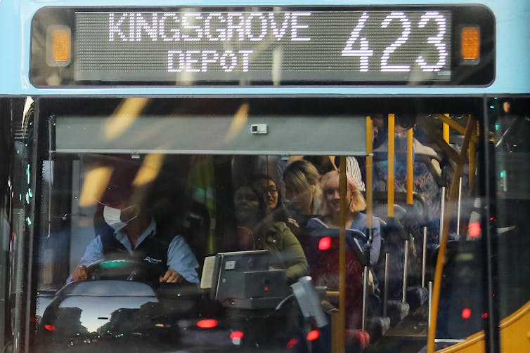 People crowd onto a bus in Sydney.