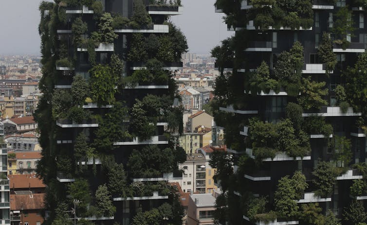 Lush green vegetation on the two residential towers.