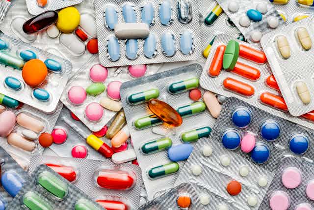 Background of a large group of assorted capsules, pills and blisters