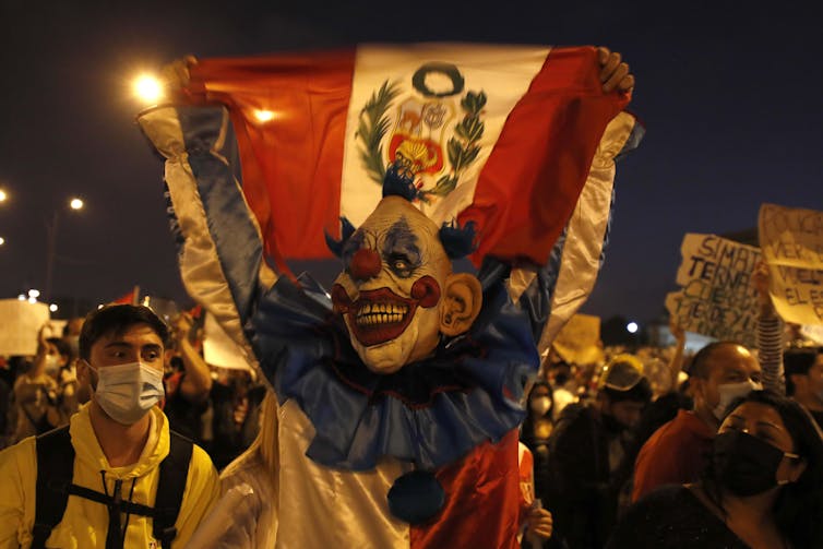 Man dressed as clown protesting on the streets of Lima, November 2020.