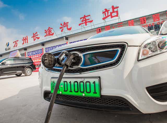 An electric car is charged in Chongqing, China, July 2018