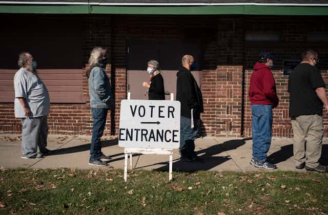 People stand in line to vote