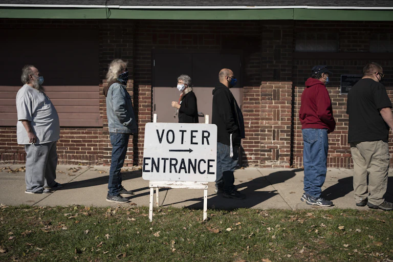 People stand in line to vote