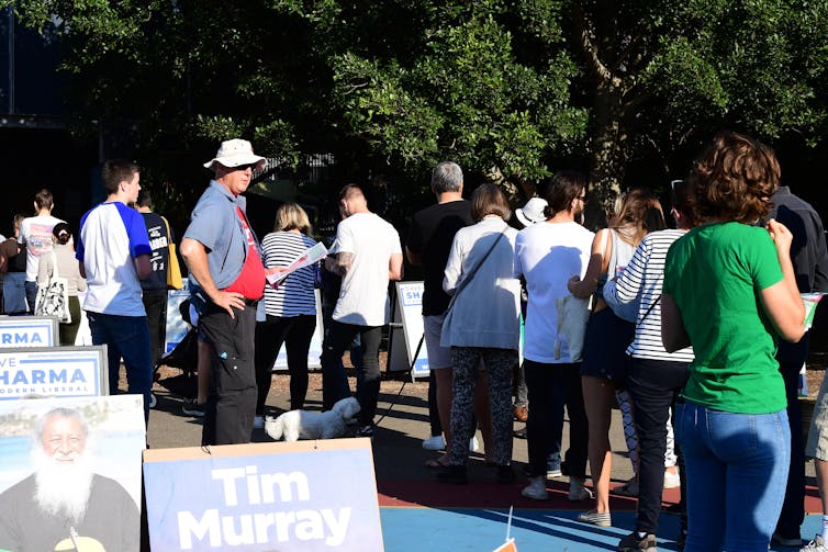 Australians line up outside a polling booth on Election Day 2019.