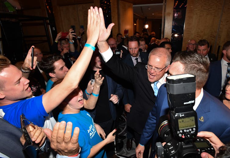 Scott Morrison high fives supporters on election night 2019.