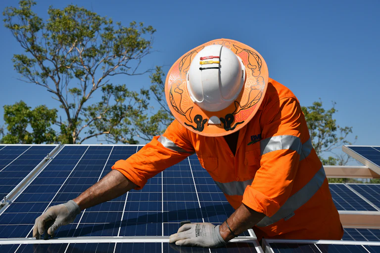 Worker installing solar panels in Daly River, Northern Territory.