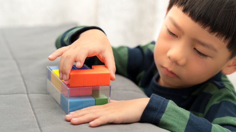 A boy plays with blocks.
