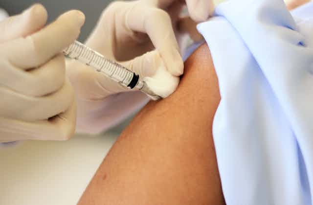 A person being vaccinated in their arm