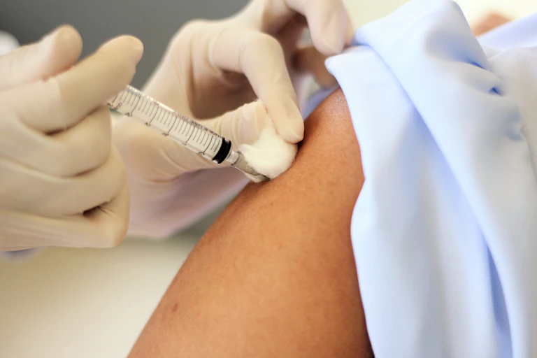 A person being vaccinated in their arm