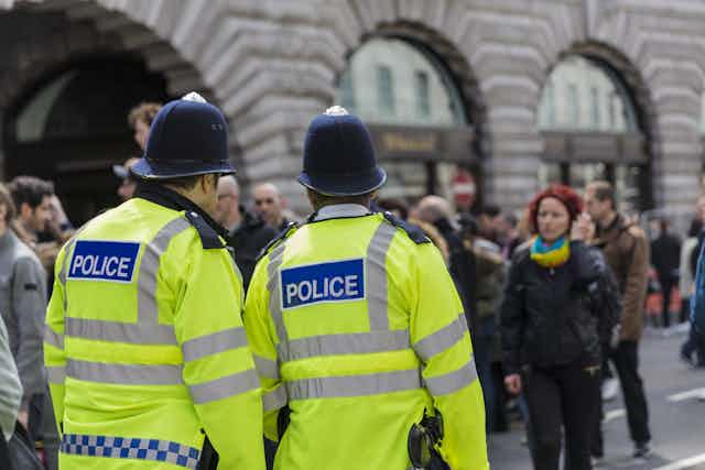 Police officers wearing high vis jackets patrolling the streets.