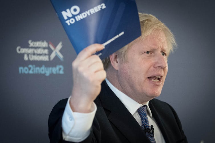 Boris Johnson waves a pamphlet for the campaign against a second Scottish independence referendum.