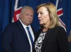 Christine Elliott with Doug Ford in the background.