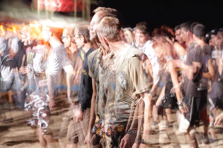Men look blurred at a public event.