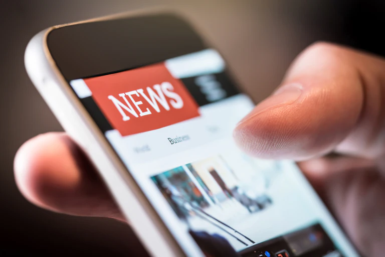 Someone reading news on their smartphone