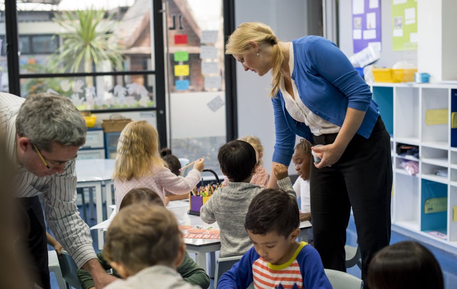 A daycare educator walks around her classroom.