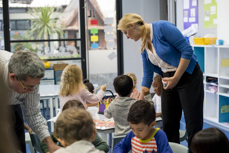 A daycare educator walks around her classroom.
