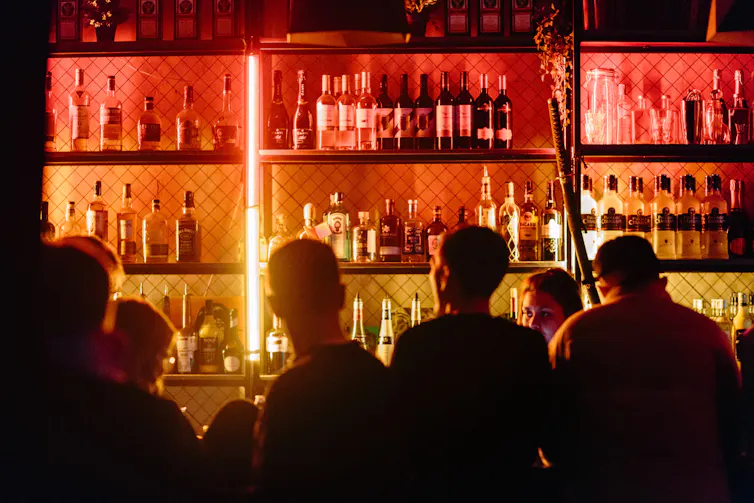 Men are seen at a bar.