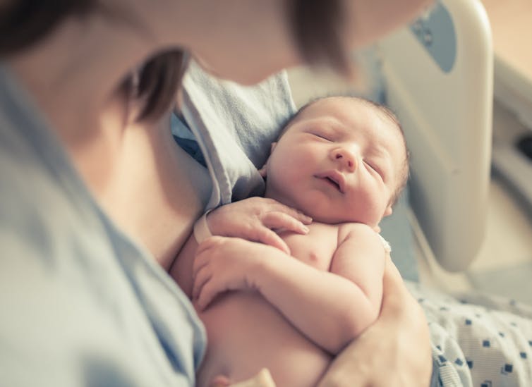 Mother holding newborn baby.