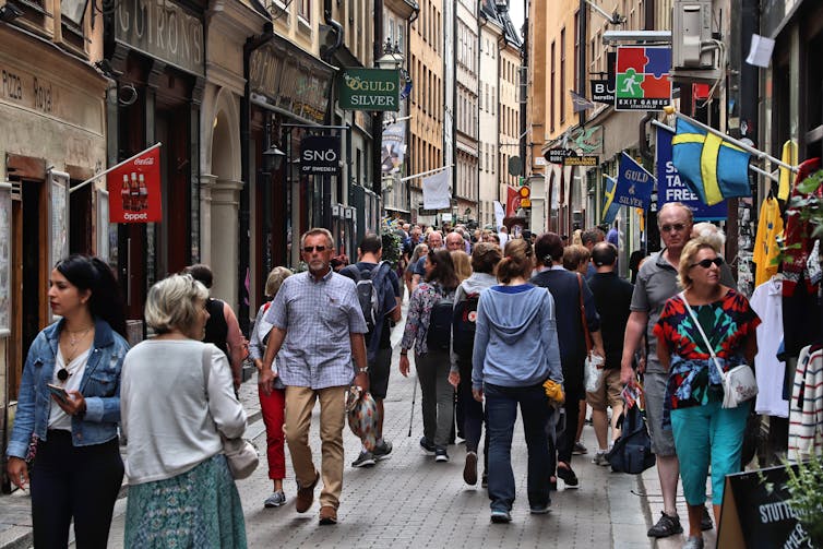 Crowds walking down street in Stockholm.