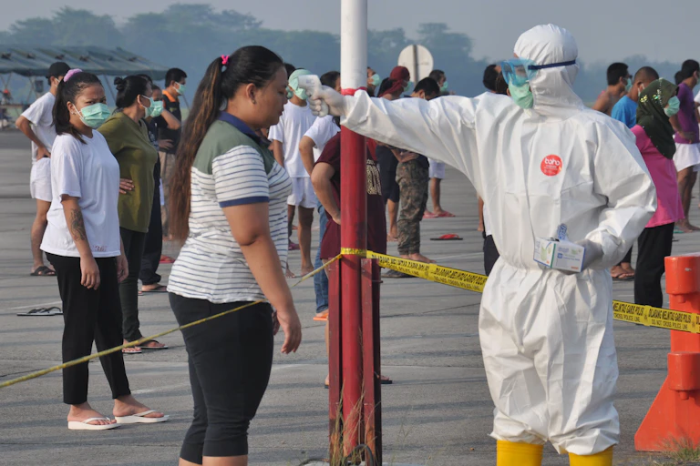 Indonesian migrant workers at a government quarantine facilities after returning from abroad