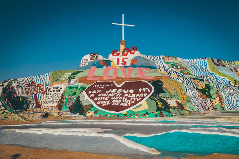 Hillside painted with religious phrases.