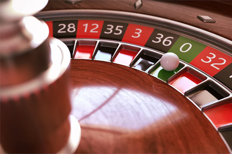 Roulette wheel, ball on zero.