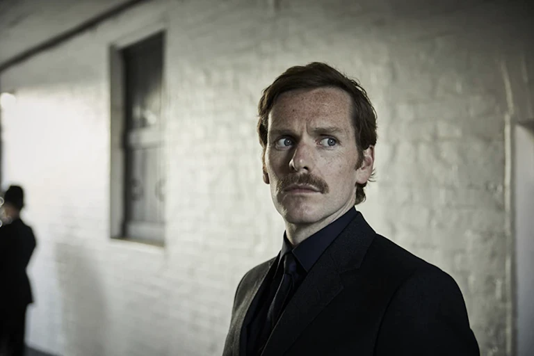 Man in suit with moustache.