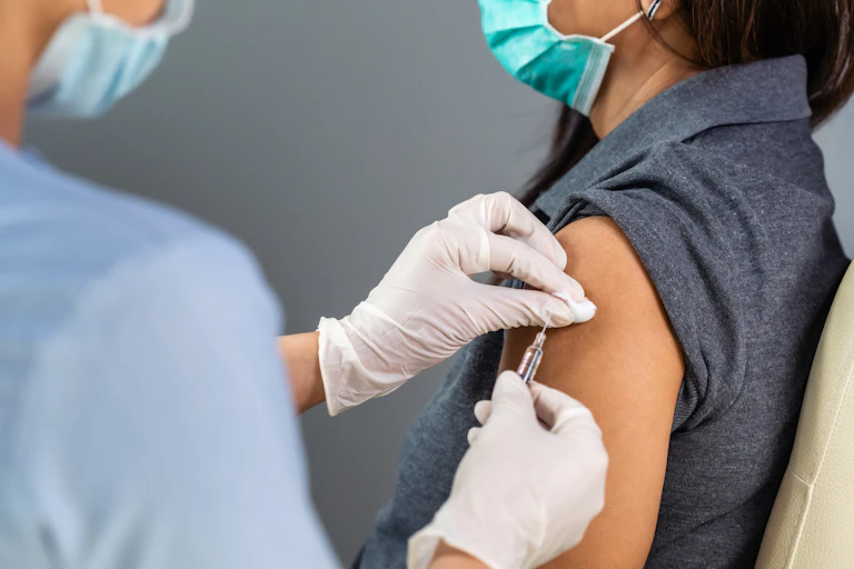 A woman gets vaccinated.