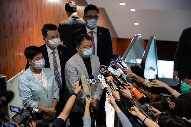 Former pro-democracy lawmakers Helena Wong, (L), Wu Chi-wai, (2L), Andrew Wan, (2R), and Lam Cheuk-ting, (R), speak to reporters.