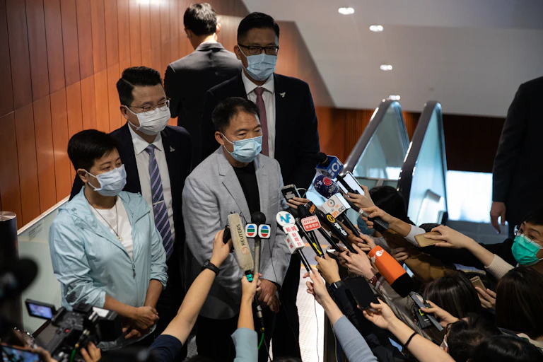 Former pro-democracy lawmakers Helena Wong, (L), Wu Chi-wai, (2L), Andrew Wan, (2R), and Lam Cheuk-ting, (R), speak to reporters.