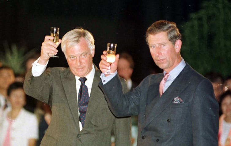 Chris Patten, the last governor of Hong Kong, and Prince Charles drinking a loyal toast in the garden of the British residency before the 1997 handover.